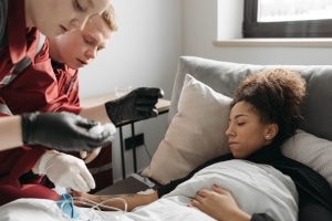 Two paramedics assisting a patient