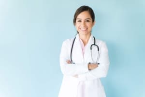 Female medical professional in a lab coat with her arms crossed